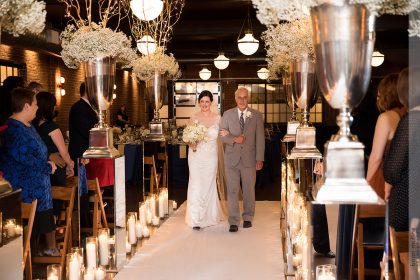 Bride and Father Walking Down Aisle in Winter White