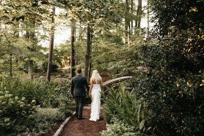Bride and Groom walking on bride at Duke Gardens